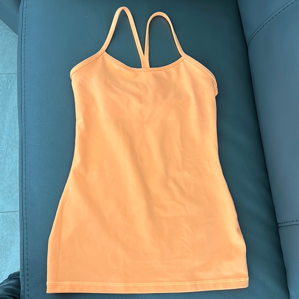 Lululemon tank size 4. NWOT bright orange. Smoke free and pet free home.